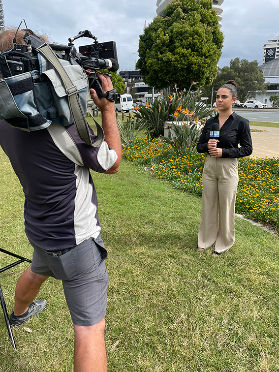 Sarah reporting in the field whilst on her internship.