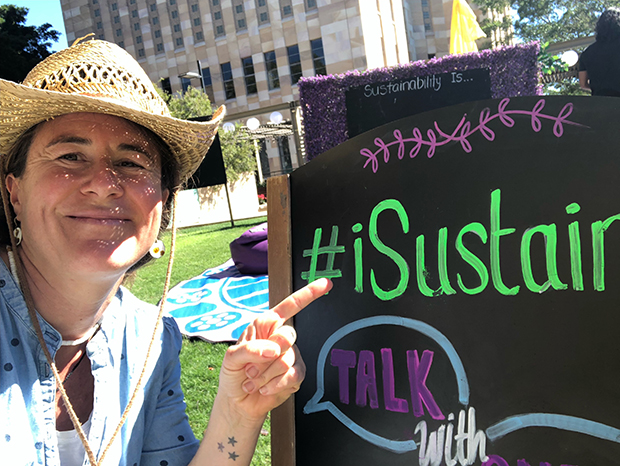 Franzisca Weder in front of a sustainability sign at UQ Sustainability Week