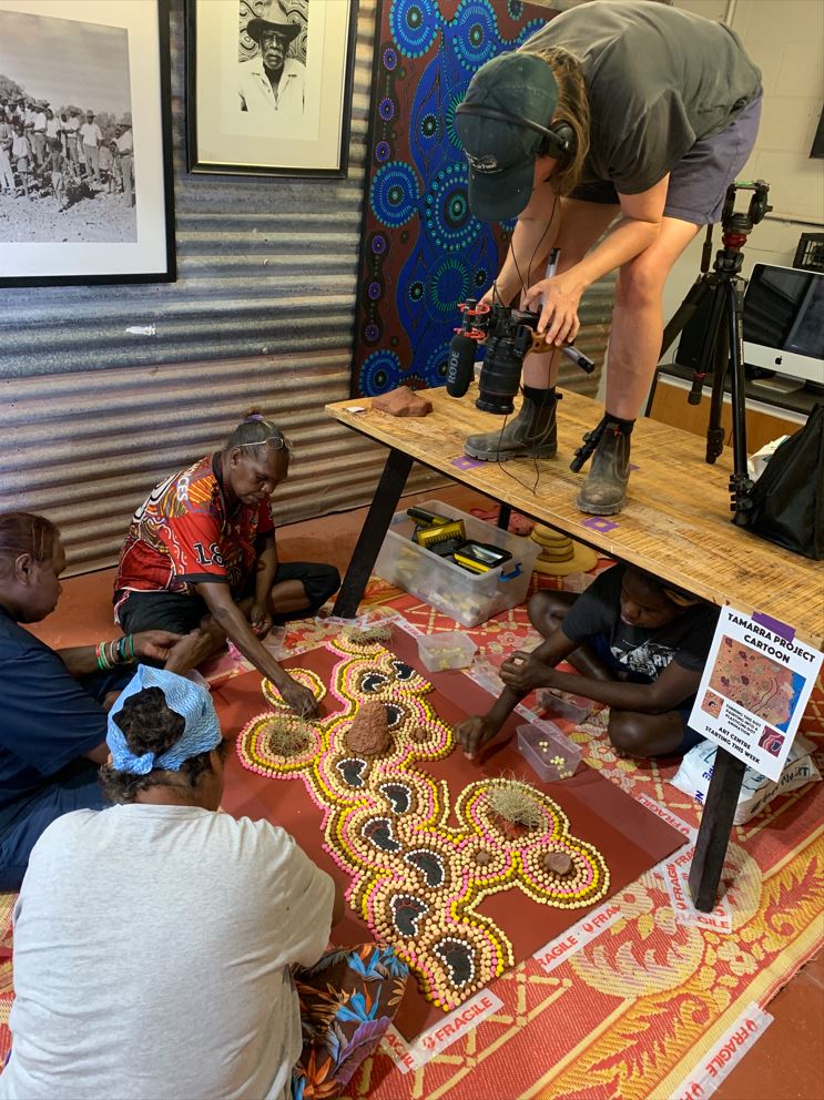 Artists Pollyanne Dixon, Cecelia Edwards, Kathy Wardle and Nadine Milner create the animation while Elle Fredericksen films from above (Photo by Briony Barr 2022, provided by the University of Queensland).