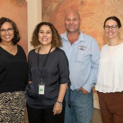 The University of Queensland Anthropology Museum launched Kirrenderri, heart of the Channel Country in March. Co-curators Tracey Hough, Mandana Mapar, the General Manager of Mithaka Aboriginal Corporation Joshua Gorringe, and co-curator Shawnee Gorringe, with photographs of Mithaka quarries and stone arrangements, March 2022. Photo: Mick Richards